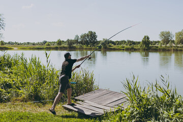 A man on a fishing trip casts a rod