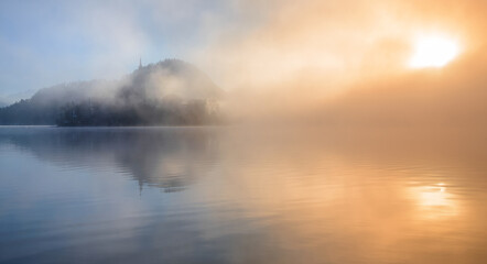 beautiful foggy morning at lake bled with mist and sun. 