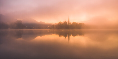Naklejka na ściany i meble Beautiful autumn mist in the morning at Lake Bled.