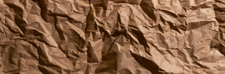 Brown crumpled, wrinkled recycle craft paper texture background banner. Wide panoramic header
