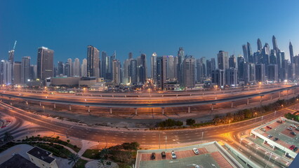 Panoraama of Dubai Marina skyscrapers and Sheikh Zayed road with metro railway aerial night to day...