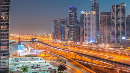 Dubai Marina skyscrapers and Sheikh Zayed road with metro railway aerial day to night timelapse,...