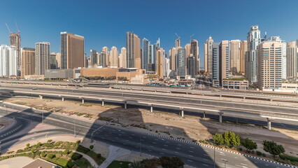 Fototapeta na wymiar Panorama showing Dubai Marina skyscrapers and Sheikh Zayed road with metro railway, United Arab Emirates