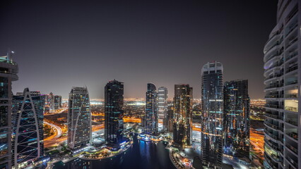 Tall residential buildings at JLT aerial night timelapse, part of the Dubai multi commodities...