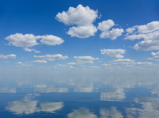 sky and water. a calm landscape of clouds reflecting in the water