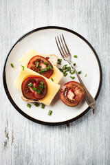 Sandwich with cheese and tomatoes. Bright wooden background. Top view. Copy space.