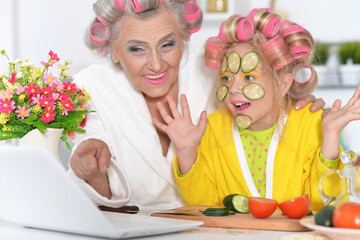 Obraz na płótnie Canvas woman and girl making mask from cucumber