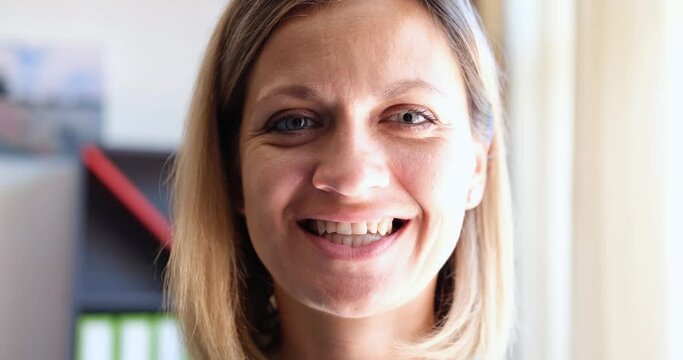 Woman inserting plastic dental cap to align teeth bite