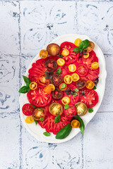 Salad with colorful tomatoes and basil 