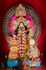 Fototapeta premium Kolkata,West Bengal,India - 10th February 2019 : Idol of Goddess Saraswati with veena, a musical instrument and white swan, a sacred bird. Hindu goddess of knowledge, music, art, wisdom, and learning.