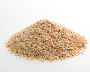 Dried granulated, chopped garlic on a white background