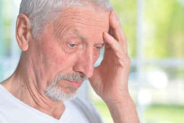 sad pensive senior man posing at home