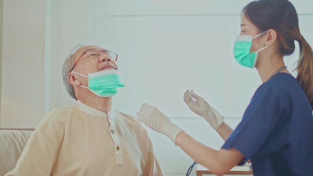 An old man is undergoing an ATK covid test. from a female nurse at home