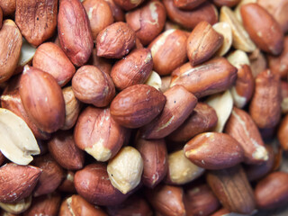Roasted unpeeled peanuts macro, peanuts as a background. Peanut/Groundnut Texture
