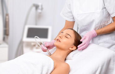 Procedure microdermabrasion on the face against acne and blackheads. Women's cosmetology in the beauty salon.