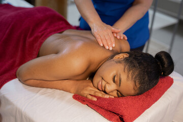 beautiful african young woman at specialist on back massage	