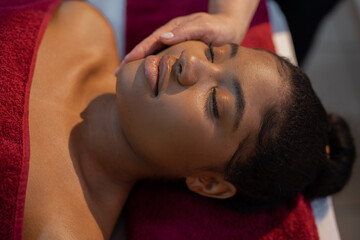 african woman in red towel on facial massage	
