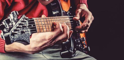 Musical instrument. Electric guitar. Repetition of rock music band. Music festival. Man playing guitar. Close up hand playing guitar. Musician playing guitar, live music