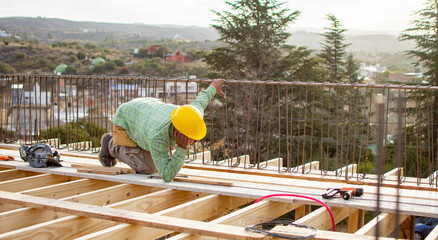 bricklayers with yellow helmet and protective glasses building an iron beam - PHOTO SESSION: WORK...