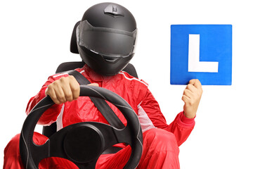 Racer with helmet in a car seat holding a learner plate - obrazy, fototapety, plakaty