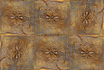 Bronze tiles with patterns on the wall. Background, texture
