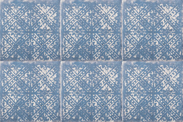 Blue tiles with white patterns on the wall. Background, texture