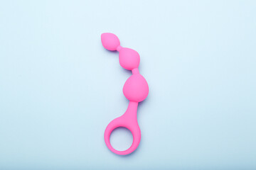 pink sex toy on blue background, adult toy for alternative sex