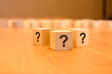 cube with question mark on wooden background. space for text - obrazy, fototapety, plakaty