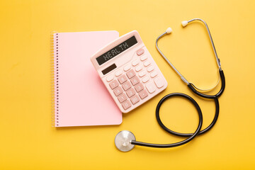 Pink beautiful calculator, notepad, stethoscope and vitamins or pills on a yellow background with a place for an inscription