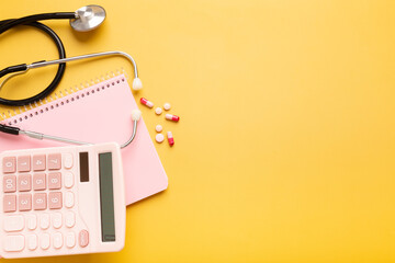 Pink beautiful calculator, notepad, stethoscope and vitamins or pills on a yellow background with a place for an inscription