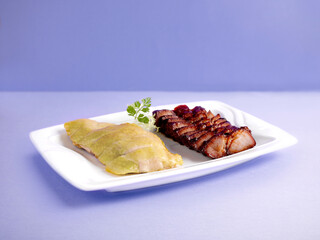 BBQ and steamed pork and chicken Combination (2 Varieties) Served in a dish isolated on wooden board side view on grey background