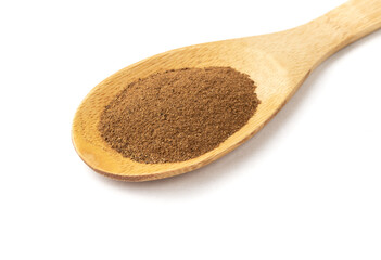 Closeup of ground cumin on a spoon isolated over white background