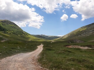 Gravel road and sky landscape, road to Lukomir on mountain Bjelasnica, Bosnia and Herzegovina