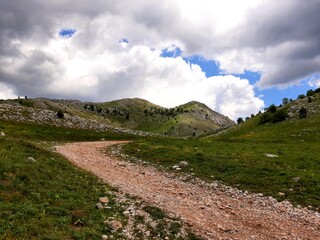 Landscape with sky and clouds, carriage road to village Umoljani, mountain Bjelasnica, Bosnia and Herzegovina
