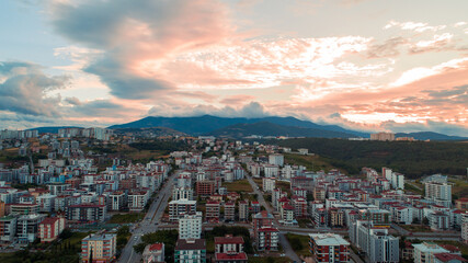 A view of a large mountain and Ondokuz Mayıs University behind the city streets, taken with a drone from the Atakum district of Samsun.