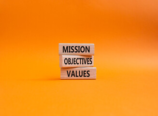 Mission Objectives Values symbol. Concept words Mission Objectives Values on wooden blocks. Beautiful orange background. Business and Mission Objectives Values concept. Copy space