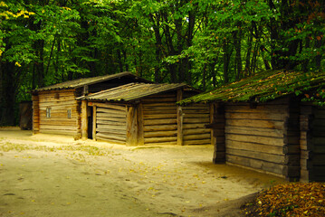 Authentic wooden farmhouses in the forest from historical area of Polisisa, 19th century. National Museum of Folk Architecture and Life of Ukraine,  Kyiv, Ukraine. 