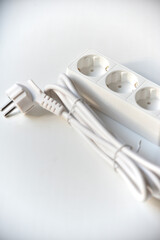 White electrical extension cord mains filter with sockets on a white background