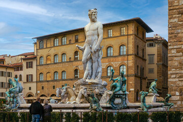 Fountain of Neptune, Firenze with people watching in front of it on a sunny day. Fountain of Neptune under blue sky in Florence, Italy. © kerocan