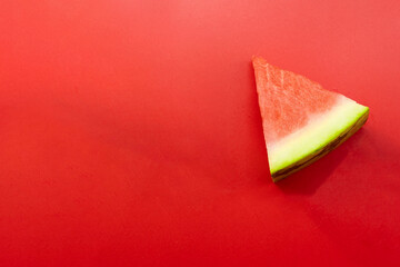 piece of watermelon on red background