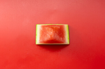 piece of watermelon on red background