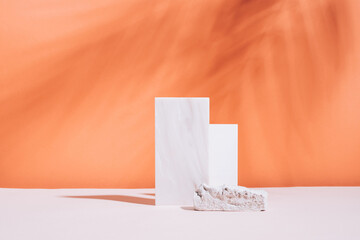 Abstract podium various geometric shapes and materials, stone glass, bright coral empty background,