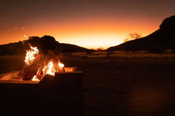 Bonfire in the sunset in the mountains in Namibia Africa