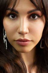 Fototapeta premium Close-up portrait of a beauty woman with full lips, straight hair and perfectly clean skin. Daytime makeup, styling and soft care. Skin care in the spa salon or cosmetology, smooth eyebrows