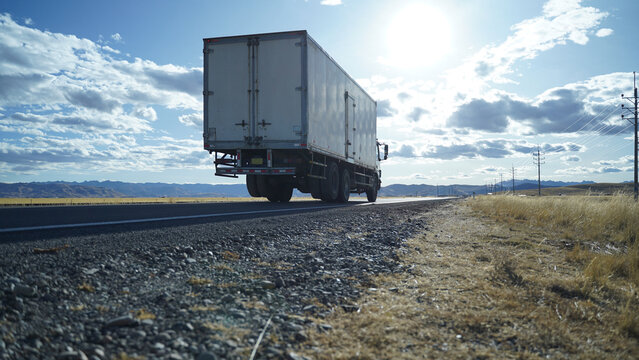 vehicle along the open compa route at sunset