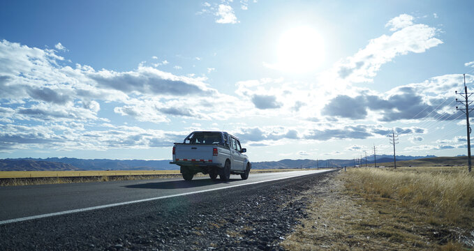 vehicle along the open compa route at sunset