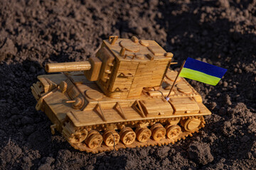 Tank on the ground with the flag of Ukraine close up