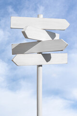 Blank white signpost on blue sky background. Choose the correct way concept. Mock up, template