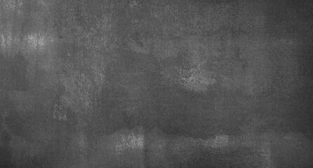 Abstract empty grungy wall background in black and grey colors. Granite or chalkboard texture in dark tones.
