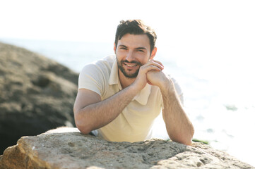 Fototapeta na wymiar Smiling man outdoor portrait near the sea, smile with teeth braces